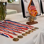 Awards table with a close up of the medals