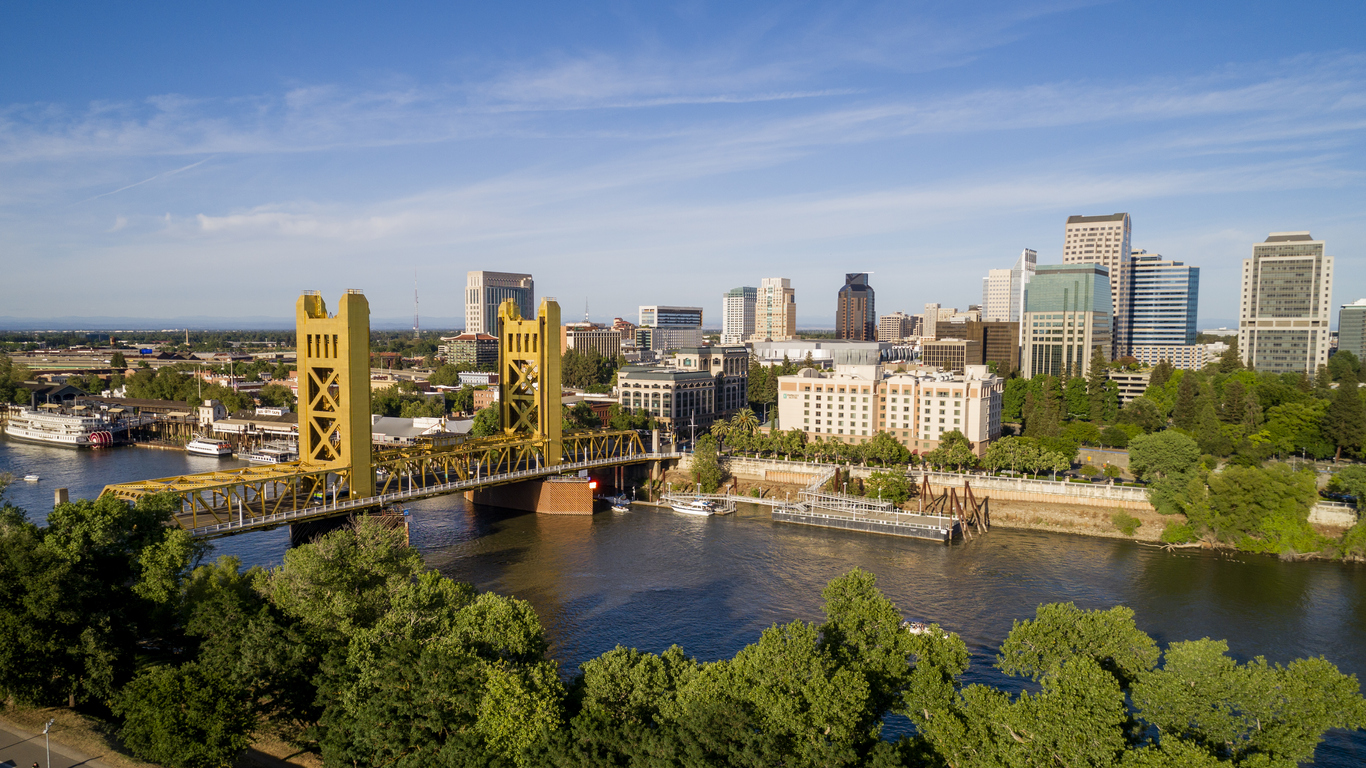 High quality stock aerial view photo of Sacramento's Tower Bridge and the Sacramento River, looking towards the Capitol mall and building